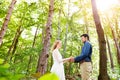 Beautiful wedding couple outside in green forest. Royalty Free Stock Photo