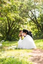 Beautiful wedding couple in park. They kiss and hug each other Royalty Free Stock Photo
