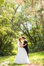 Beautiful wedding couple in park. They kiss and hug each other Royalty Free Stock Photo