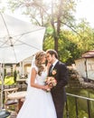 Beautiful wedding couple in park. They kiss and hug each other Royalty Free Stock Photo