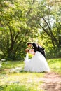 Beautiful wedding couple in park. They kiss and hug each other Royalty Free Stock Photo