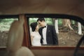 Beautiful wedding couple posing near splendid retro car Royalty Free Stock Photo