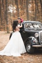 Beautiful wedding couple posing near splendid retro car Royalty Free Stock Photo