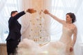 Beautiful wedding couple is pouring champagne indoors. Royalty Free Stock Photo