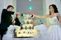 Beautiful wedding couple is pouring champagne indoors Royalty Free Stock Photo