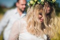 Beautiful wedding couple walking on field, bride and groom posing on wheat field with blue sky Royalty Free Stock Photo