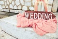 Beautiful wedding decoration on stony stairs with wooden arrow wedding. Big candle lanterns with pink flowers and Royalty Free Stock Photo