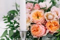 Beautiful wedding floral decoration on a table in a restaurant. White tablecloths, bright room, candles, close-up shooting. The ev Royalty Free Stock Photo