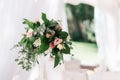 Beautiful wedding floral decoration on a table in a restaurant. White tablecloths, bright room, candles, close-up shooting. The ev Royalty Free Stock Photo