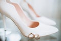 Beautiful wedding ring on the bride`s white shoes Royalty Free Stock Photo