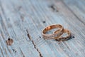 Beautiful wedding rings on a blue wooden background. Royalty Free Stock Photo