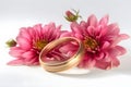 Beautiful wedding rings on a light background, which are adorned with flowers. Rings are a symbol of marriage and love.