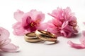 Beautiful wedding rings on a light background, which are adorned with flowers. Rings are a symbol of marriage and love. Royalty Free Stock Photo