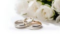 Beautiful wedding rings on a light background, which are adorned with flowers. Rings are a symbol of marriage and love.