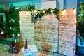 Beautiful wedding set decoration in the restaurant. Rustic wooden photo zone