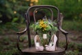 Beautiful wedding shoes with high heels and a bouquet of colorful flowers on a vintage chair on the nature in sunset light Royalty Free Stock Photo