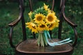 Beautiful wedding shoes with high heels and a bouquet of sunflowers on a vintage chair Royalty Free Stock Photo