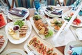 Beautiful wedding table set in a restaurant with food on plates, decor and candlesticks on a white tablecloth Royalty Free Stock Photo