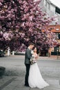 Beautiful wedding walk in the flowered park of the bride and groom Royalty Free Stock Photo