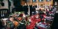 Beautiful weding table decoration with red fresh flowers and candles