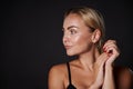 Beautiful well-groomed young Caucasian woman with blond hair, clean radiant healthy tanned skin and well-groomed manicure looks Royalty Free Stock Photo