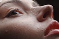 Beautiful wet female face with raindrops on it