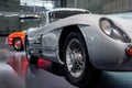 Beautiful wheels and front. Right side of the great white retro vehicle standing indoors at car show Royalty Free Stock Photo