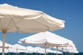 Beautiful white beach umbrellas against blue sky, closeup Royalty Free Stock Photo