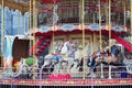 Beautiful white and black horses carousel in a holiday park. Merry-go-round carrossel with horses