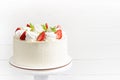 Beautiful white cake decoraited with meringue and fresh strawberries. White background Royalty Free Stock Photo