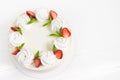 Beautiful white cake decoraited with meringue and fresh strawberries. White background Royalty Free Stock Photo