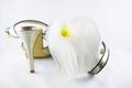 Beautiful white calla lily lying on golden women`s sandals.