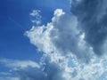 Beautiful white clouds against the blue sky with a trace of the plane Royalty Free Stock Photo