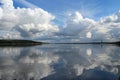 Beautiful white clouds on blue sky with reflection in lake during the day in the natural environtent.