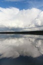 White clouds on blue sky with reflection in lake during the day in the natural environtent.