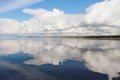 Beautiful white clouds on blue sky with reflection in lake during the day in the natural environtent. Royalty Free Stock Photo