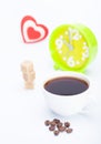 Beautiful white cup, coffee, hearts with an alarm clock on a white background