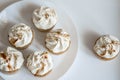 Beautiful white cupcakes on a white plate