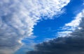 Beautiful white and dark clouds, rain, cumulus clouds against a blue sky. Picturesque, fantastic clouds. Plain landscape Royalty Free Stock Photo