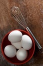 Beautiful White Eggs with Stainless Steel Wisk on Weathered Wood