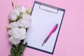 Beautiful white flowers. Eustoma bouquet with a blank for text on a bright pink background. view from above Royalty Free Stock Photo