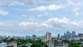 Beautiful white fluffy cloud formation on vivid blue sky in a sunny day above big city, view from rooftop Royalty Free Stock Photo
