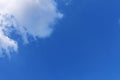 Beautiful white fluffy cloud on left top edge under deep blue sky. Amazing clear sky day for background