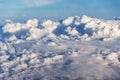 Beautiful white fluffy clouds viewed from airplane, blue sky background, aerial view, copy space Royalty Free Stock Photo