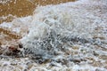Sea water surface with foam and ripples close up as background. Royalty Free Stock Photo
