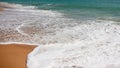 Beautiful white foamy water patterns on shallow sandy ocean beach Royalty Free Stock Photo