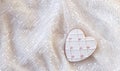 Beautiful White Gingerbread Heart on a Light Background with Sequins. A Magical Holiday Atmosphere. The concept of