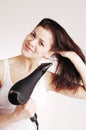 Beautiful white girl drying her hair with a hairdr Royalty Free Stock Photo