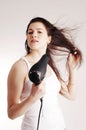 Beautiful white girl drying her hair with a hairdr Royalty Free Stock Photo