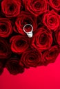 Beautiful white gold pearl ring and bouquet of red roses, luxury jewelry love gift on Valentines Day and romantic holidays Royalty Free Stock Photo